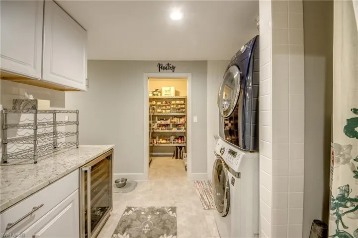 Laundry Room with wine cooler and view to pantry