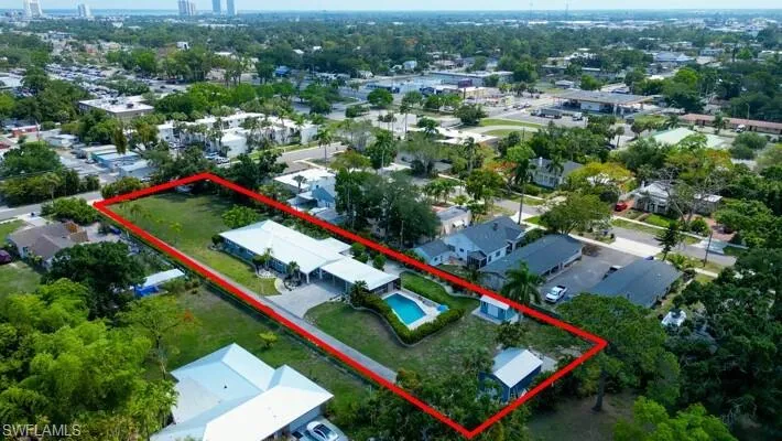 Aerial view of property and surrounding area with property parcel outlined