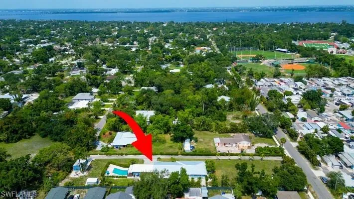 Aerial perspective of suburban area with a nearby body of water