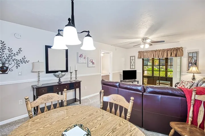Dining space featuring carpet flooring and ceiling fan