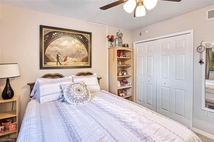 Bedroom featuring ceiling fan and a closet
