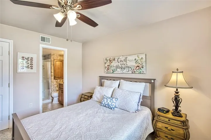 Bedroom featuring ensuite bath and ceiling fan