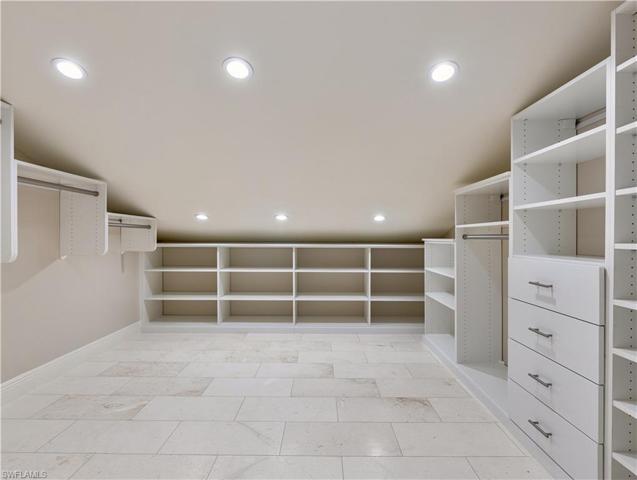 Large walk-in custom closet with lockout, primary suite, second floor