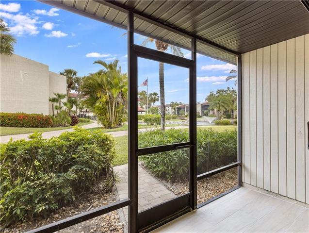 Rear patio from living area with walkway to pool area