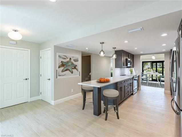 Kitchen - Entry foyer to left. Laundry and closet doors on left. Dining and rear porch in background