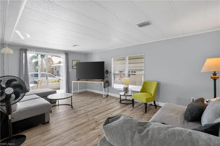 Living room featuring wood finished floors and a textured ceiling