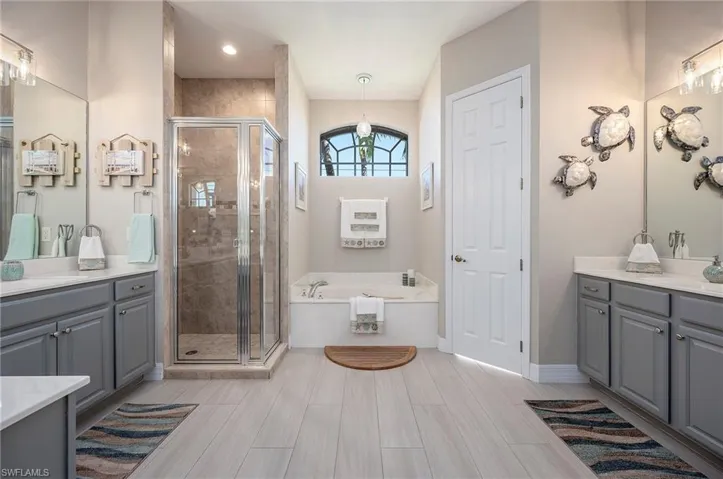 Primary Bathroom featuring Dual Sinks, Separate Tub & Shower