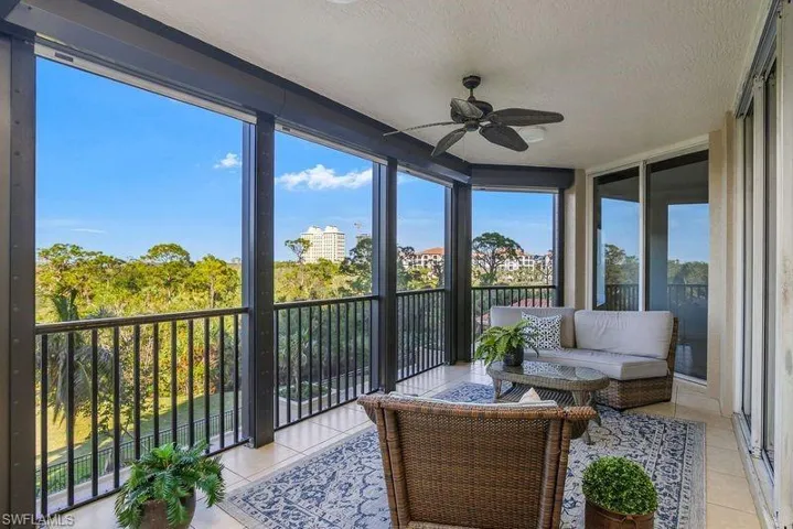 Sunroom featuring ceiling fan and plenty of natural light