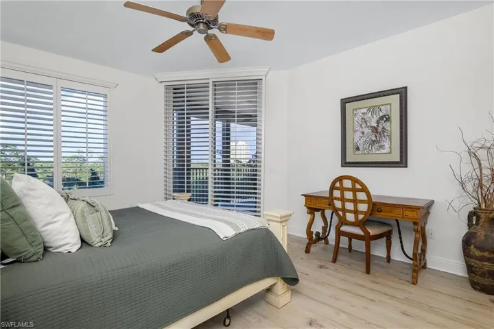 Bedroom with light hardwood / wood-style floors and ceiling fan