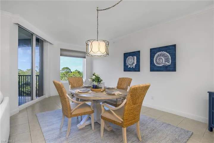 Dining space with ornamental molding and light tile patterned floors