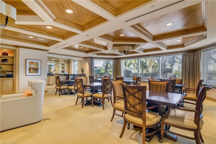 Dining room featuring crown molding, coffered ceiling, light carpet, and wooden ceiling