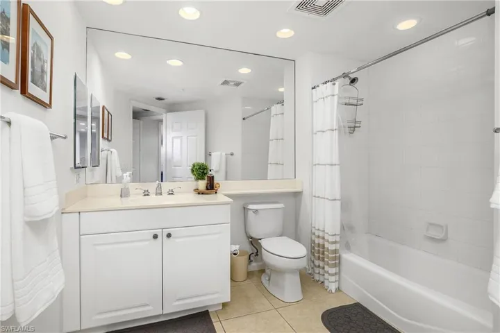 Full bathroom featuring tile patterned flooring, vanity, shower / bath combo, and toilet
