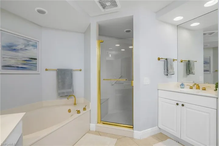 Bathroom with vanity, independent shower and bath, and tile patterned flooring