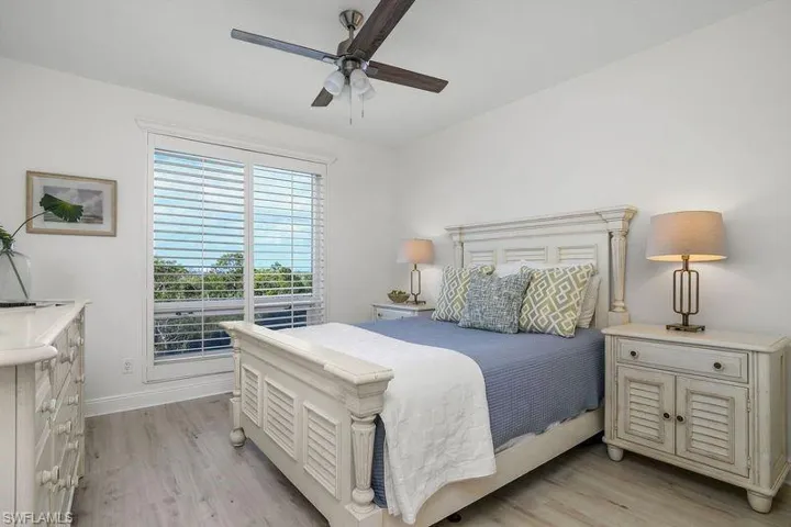 Bedroom with ceiling fan and light wood-type flooring