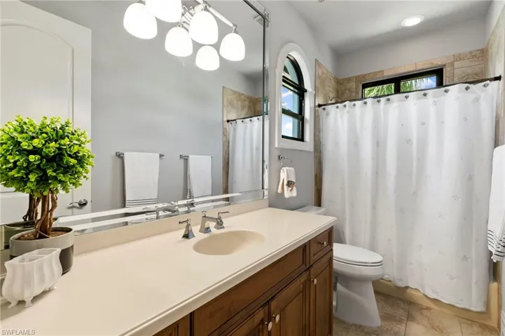 Bathroom featuring vanity and shower / bath combo