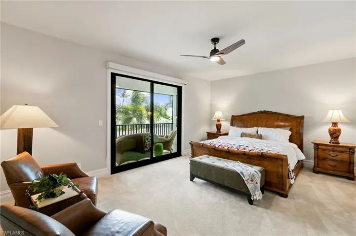 Bedroom with access to outside, carpet flooring, and ceiling fan