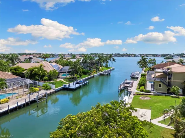 Aerial perspective of suburban area with a nearby body of water