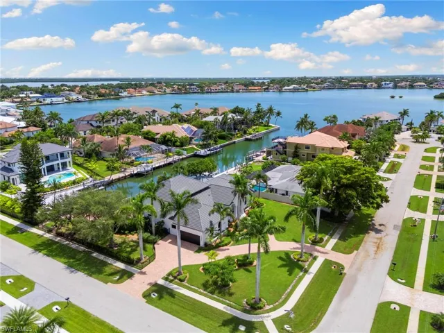 Aerial perspective of suburban area with a nearby body of water