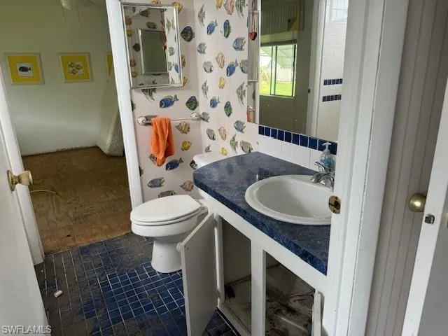 Bathroom with vanity, tile patterned flooring, and toilet