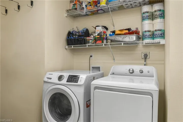 Laundry Room featuring washing machine and clothes dryer and extra storage