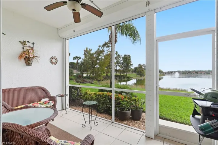Sunroom featuring a water view and a ceiling fan