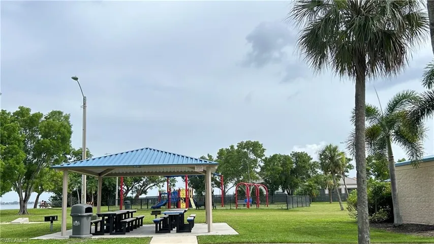 View of home's community park with a yard and a playground