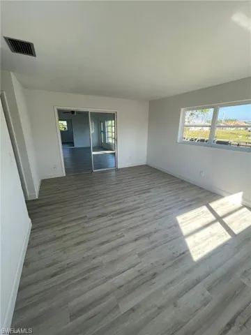 Main bedroom with in-suite bathroom, walk-in closet and canal/landscaping views