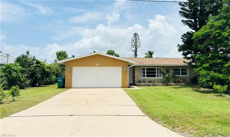 Ranch-style house with a garage and a front yard