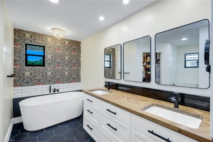 Primary bathroom features dual sinks and a large soaking tub.