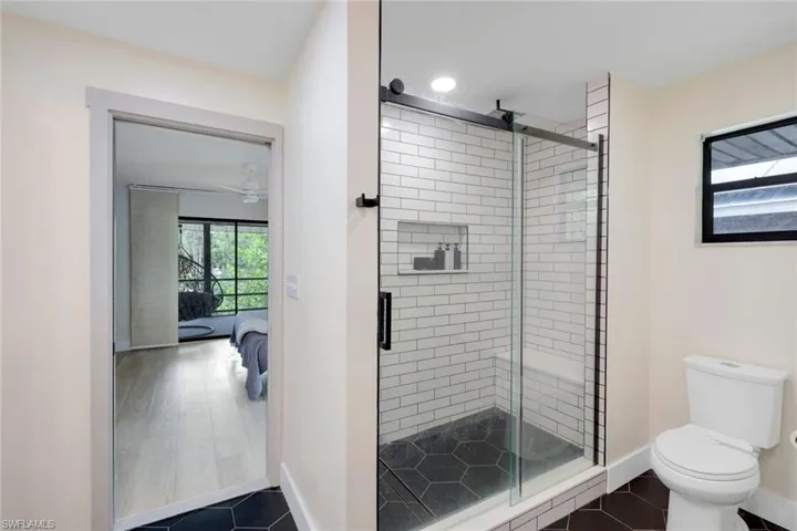 Primary bathroom features walk-in shower and large soaking tub.