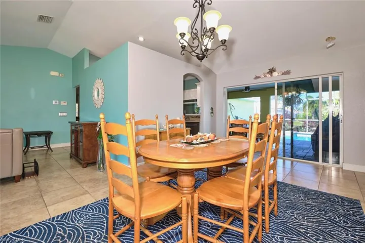 Can be used as a dining area or enough room for a formal dining room.  Triple sliders to the pool/lanai/canal.  Great breezes!