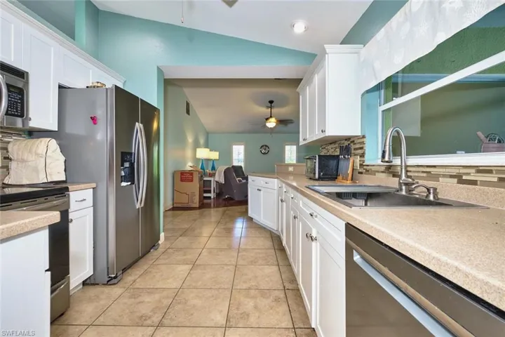 Nice workable kitchen.  Stainless steel appliances and corian countertops with glass backsplash.