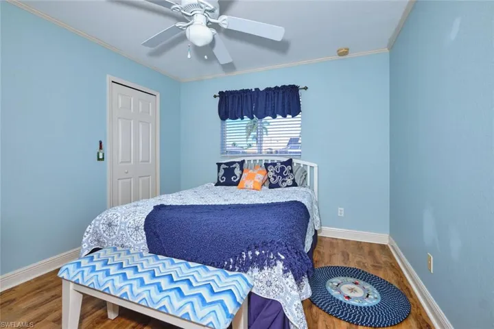 Bedroom number two also has a closet with wood planking flooring.