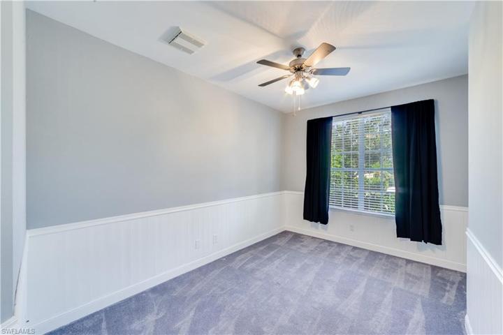 Bedroom with a walk in closet and desk alcove.