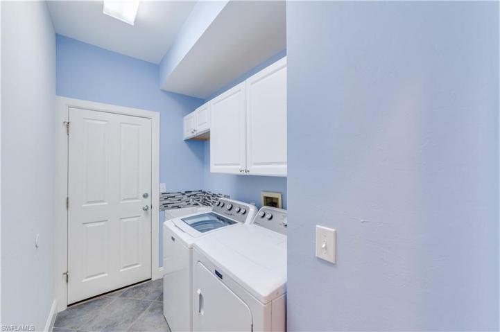 Clean and convenient--laundry room with wash basin and door into garage.