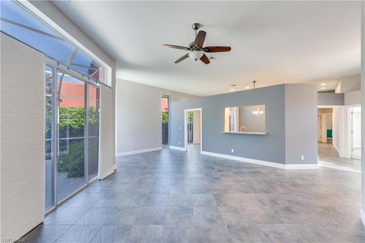 Open and expansive living room space with perfect area for study/office desk. All walls are painted white. Sliders and transom windows have sun tinting film.