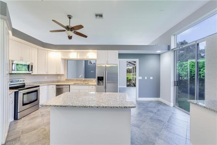 Updated, large kitchen with eat in space and center island. Convenient sliders to outdoor side space. Note: gray walls and trim are now painted white.