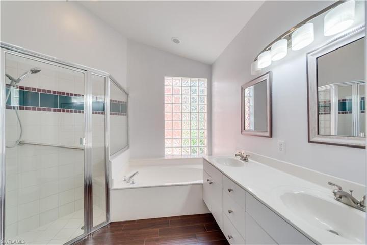 Primary bath with shower and tub, double sinks and natural light.