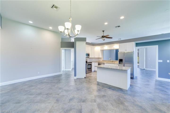 View looking from dining area into kitchen and front hall.