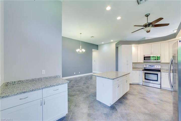 Open kitchen view overlooking dining area. Nice extra storage. Gray walls are now white.