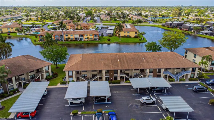 Aerial view of condo building and lake