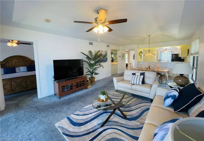 Living room open concept with trey ceilings