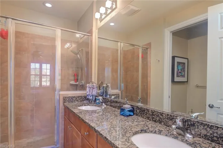 Bathroom with vanity and a shower with shower door