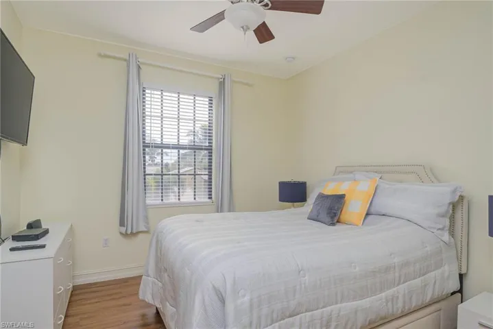 Bedroom featuring ceiling fan and wood-type flooring
