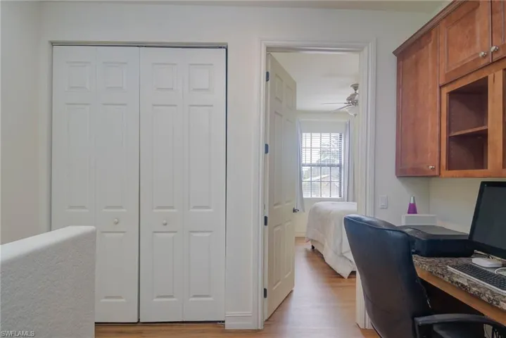 Home office featuring ceiling fan and light wood-type flooring