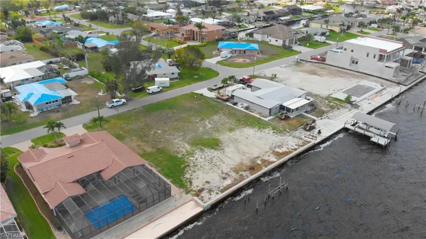 Aerial view of residential area featuring a nearby body of water