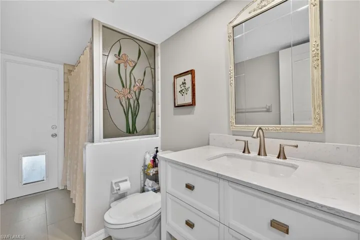 Full bath featuring curtained shower and vanity