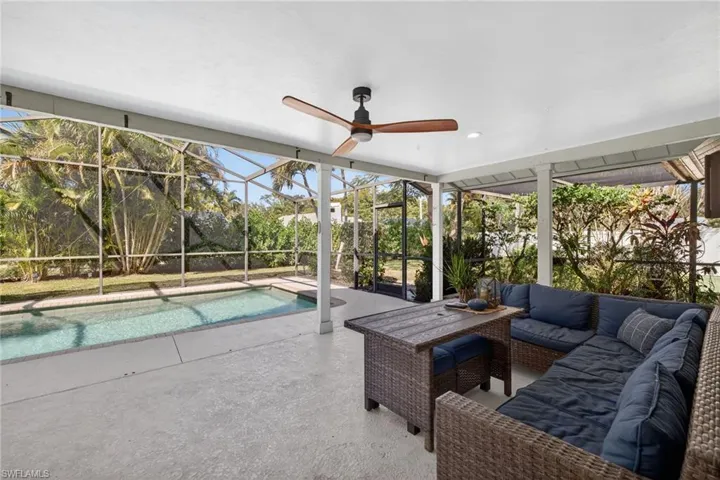 Swimming pool with a patio, a lanai, a sunroom, and an outdoor lounge area
