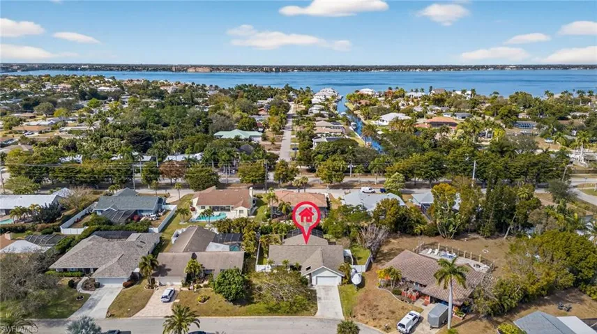 Aerial view of property and surrounding area featuring nearby suburban area