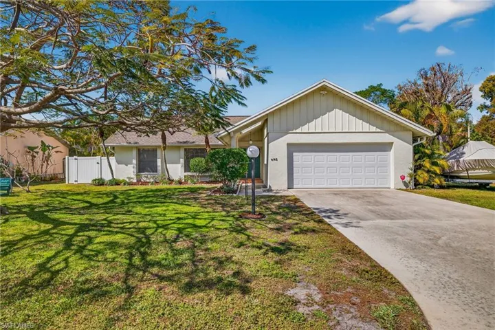 Ranch-style house with driveway and an attached garage